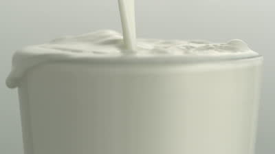 stock-footage-milk-overflowing-in-a-glass